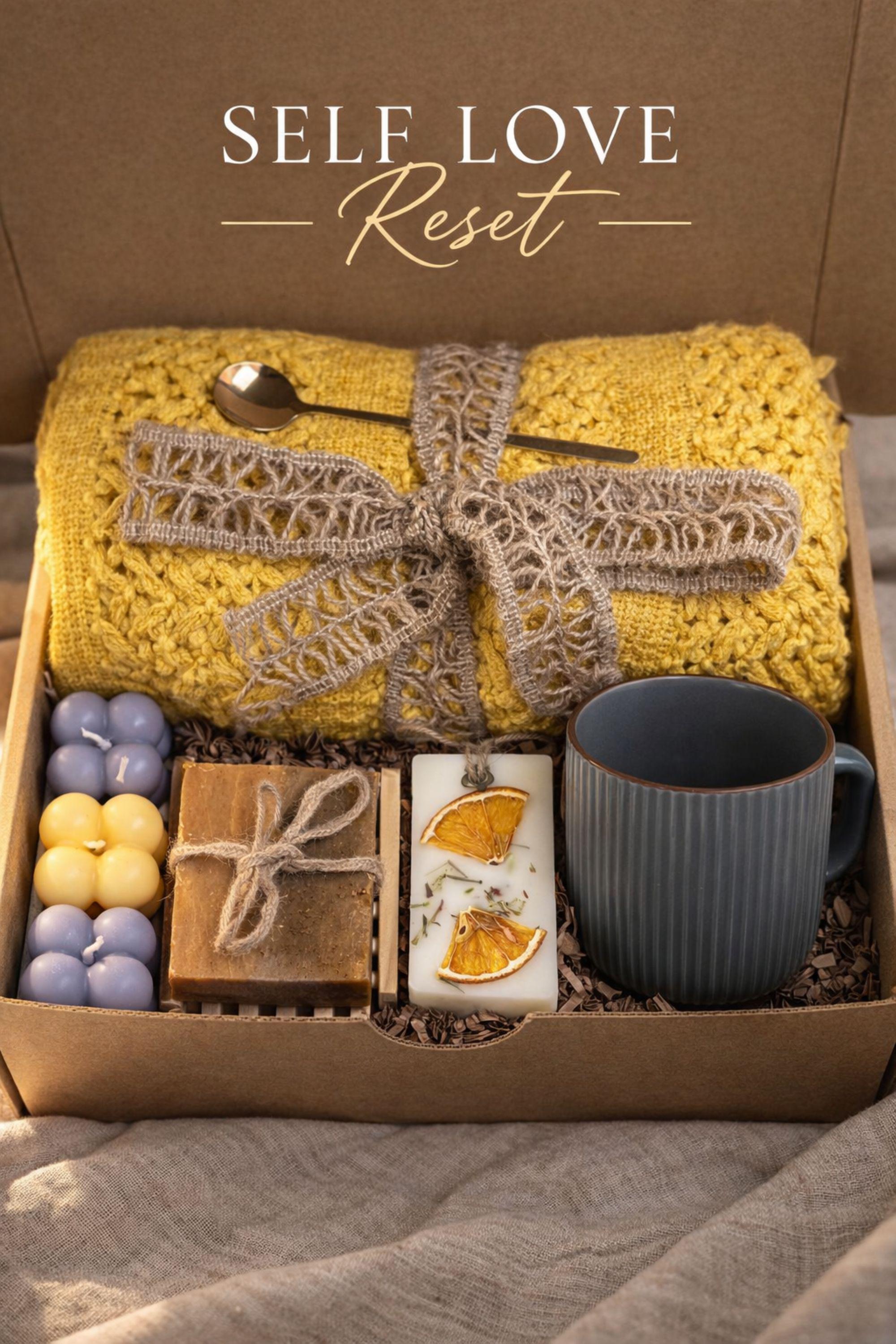 Self Love Reset gift box for women displayed on warm neutral linen background with soft window light, featuring yellow knit blanket, handmade natural soap, pastel bubble candles, citrus wax tablet with dried orange slices, ceramic mug and wooden soap dish. Emotional healing care package for new beginnings, self care gift for her, breakup recovery support box, thoughtful reset present.