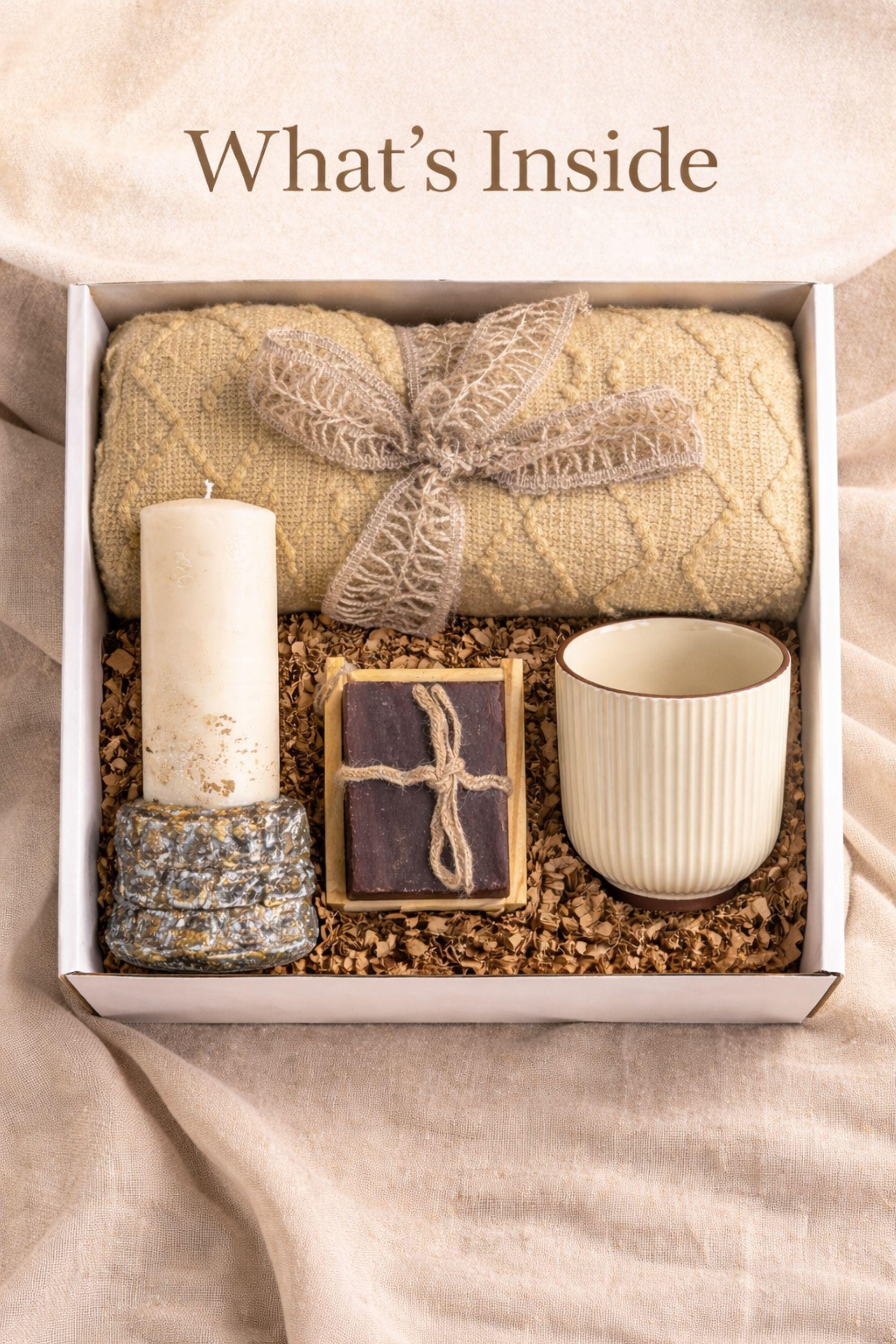 Thinking of You care package gift box featuring cozy knit blanket, handmade pillar candle on textured base, artisan soap with wooden holder, ribbed ceramic mug with spoon, beautifully arranged in a large white gift box. Comfort gift for women, sympathy support box, get well soon present, self care package, cozy curated gift ready to send.