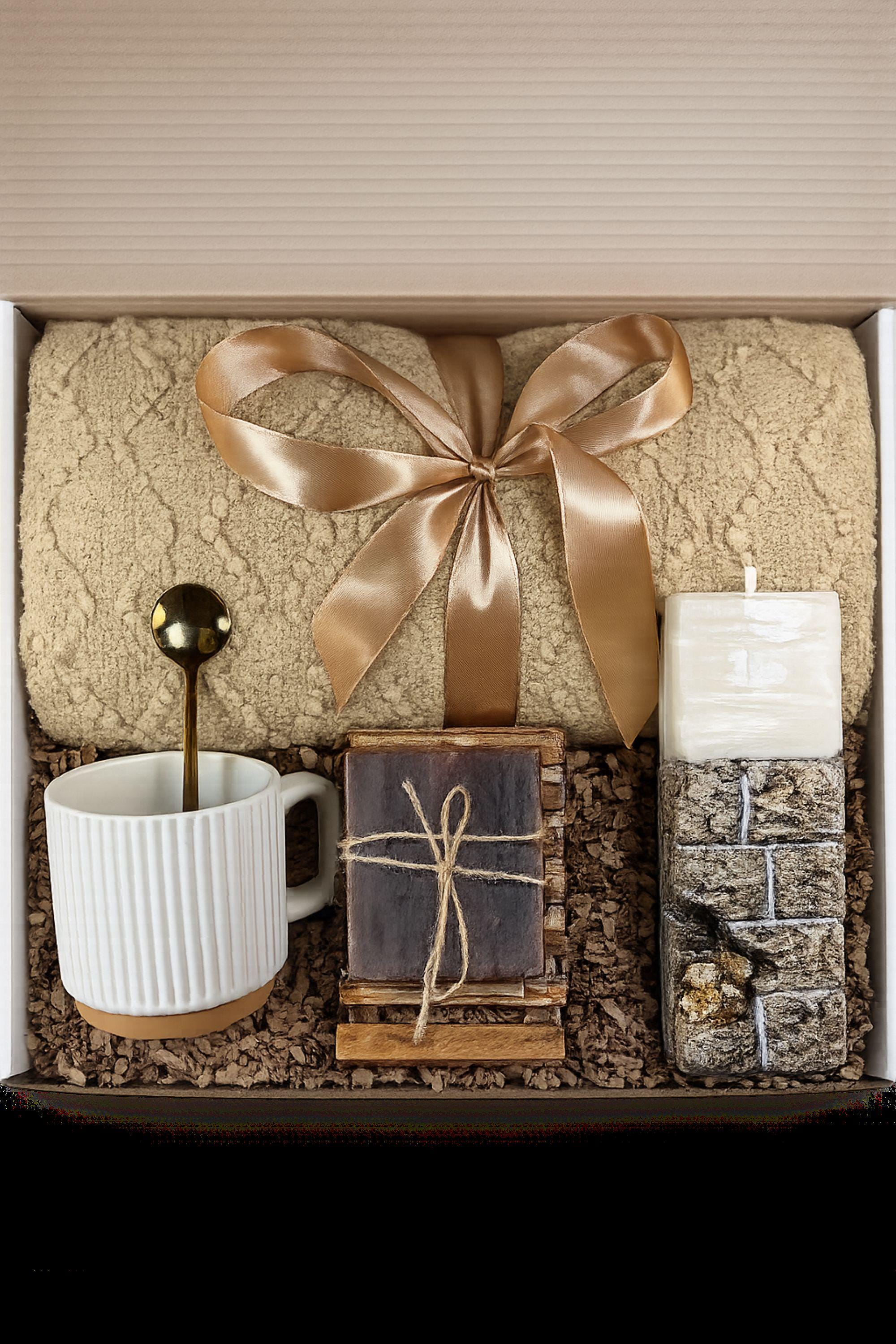 Sympathy gift box for loss of husband displayed on mouse grey linen background, open white 10x13x5 comfort care package featuring handmade 24K textured candle with stone base, cozy knit blanket tied with satin ribbon, cream ceramic mug with spoon, natural handmade soap on wooden holder, and rustic crinkle paper filler. Bereavement gift for grieving wife, condolence present, memorial comfort box, grief support package designed to send love and healing.