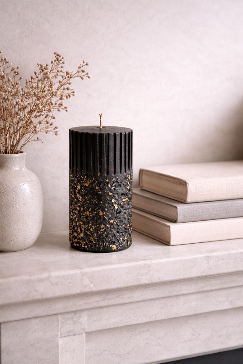 Single black sculptural wax object photographed in a calm, minimal composition to study silhouette, texture, and vertical rhythm. The ribbed structure and textured surface reinforce AuraBox’s form-focused design language.