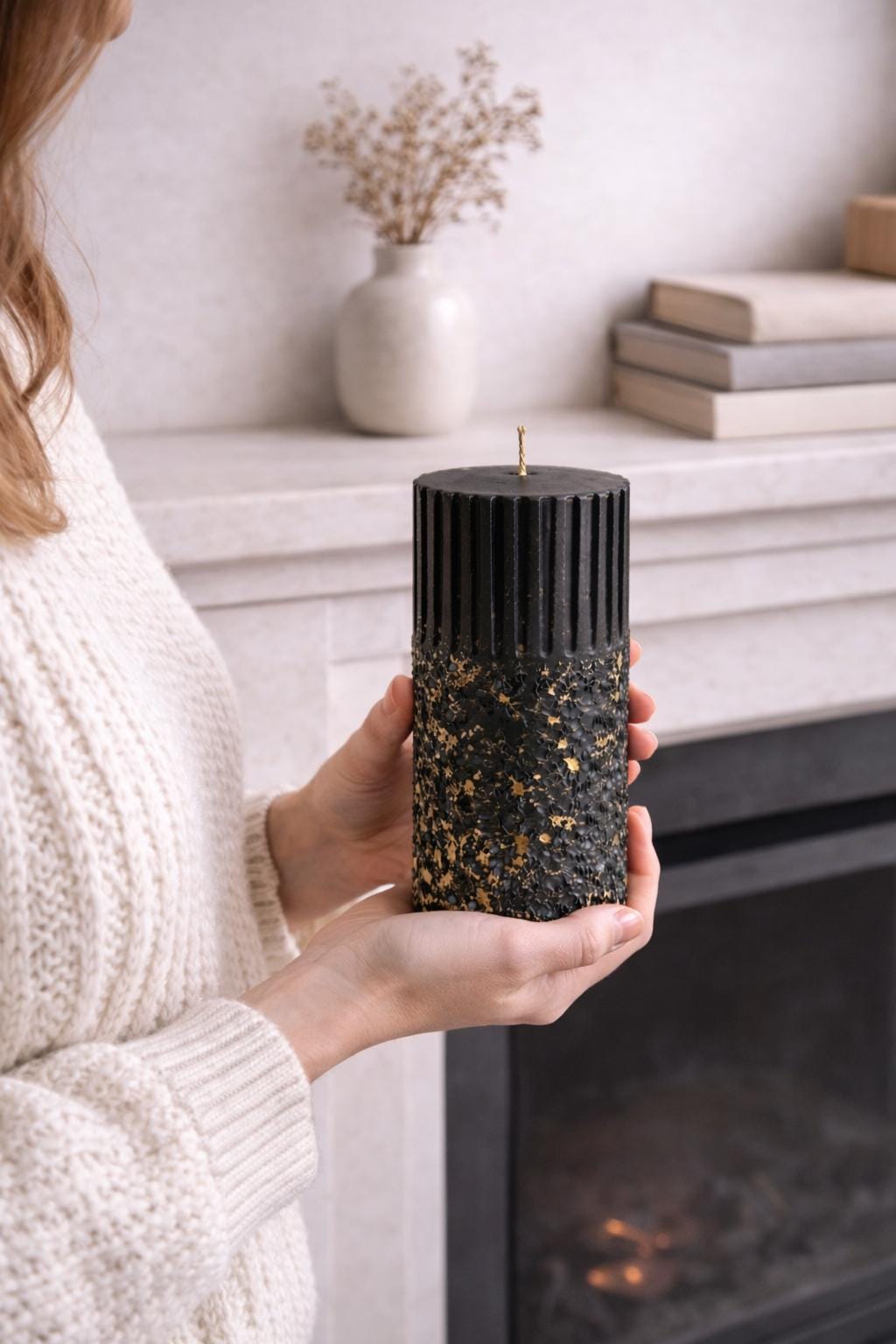 Single black sculptural wax object photographed in a calm, minimal composition to study silhouette, texture, and vertical rhythm. The ribbed structure and textured surface reinforce AuraBox’s form-focused design language.