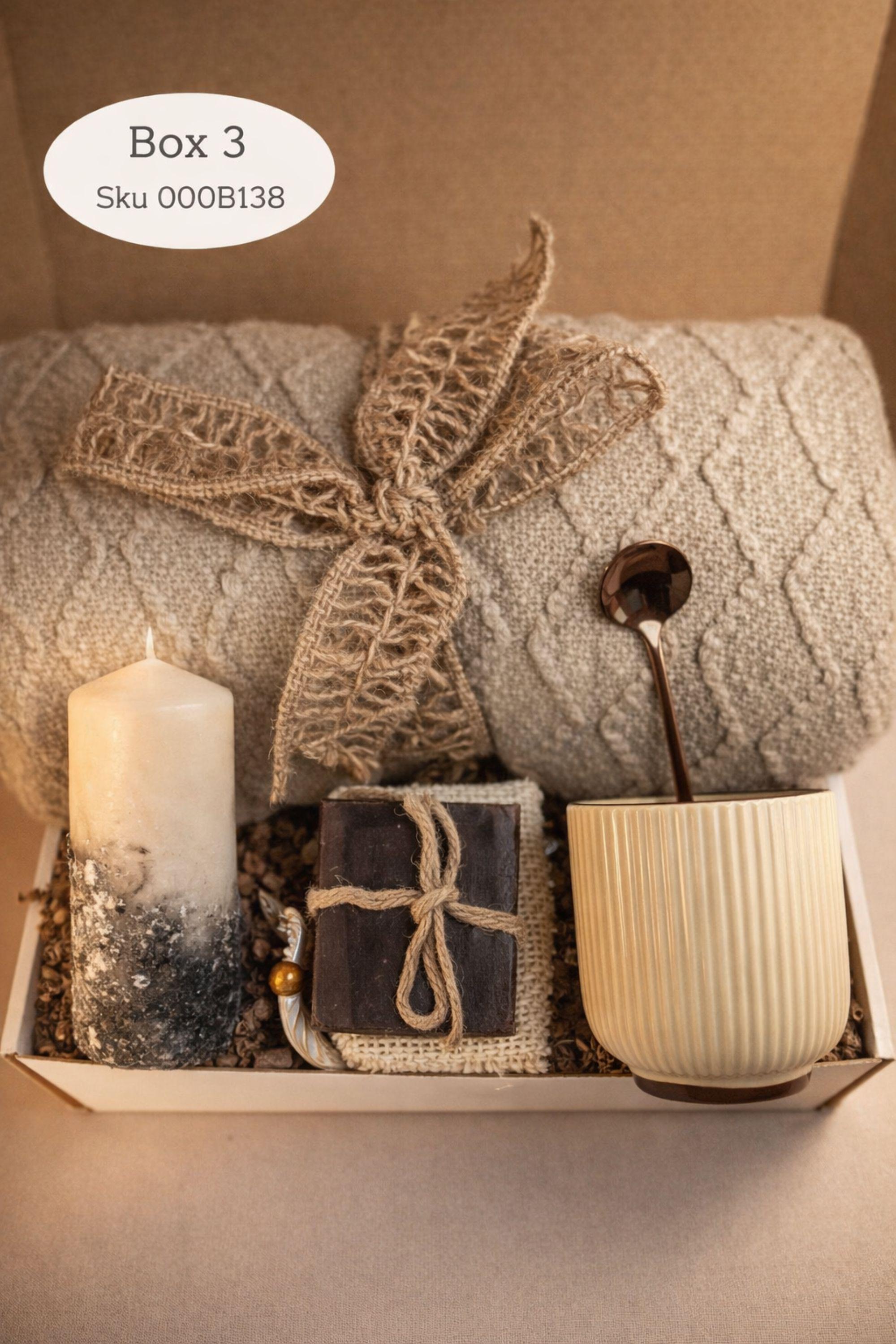 Sending You Hugs grief support gift box with sage knit blanket, ribbed green ceramic mug, handmade two-tone artisan soap, stainless steel spoon, and three bubble candles arranged inside kraft box on warm beige linen background. Sympathy care package designed for comfort during difficult times, loss support, thinking of you gift, and emotional encouragement.