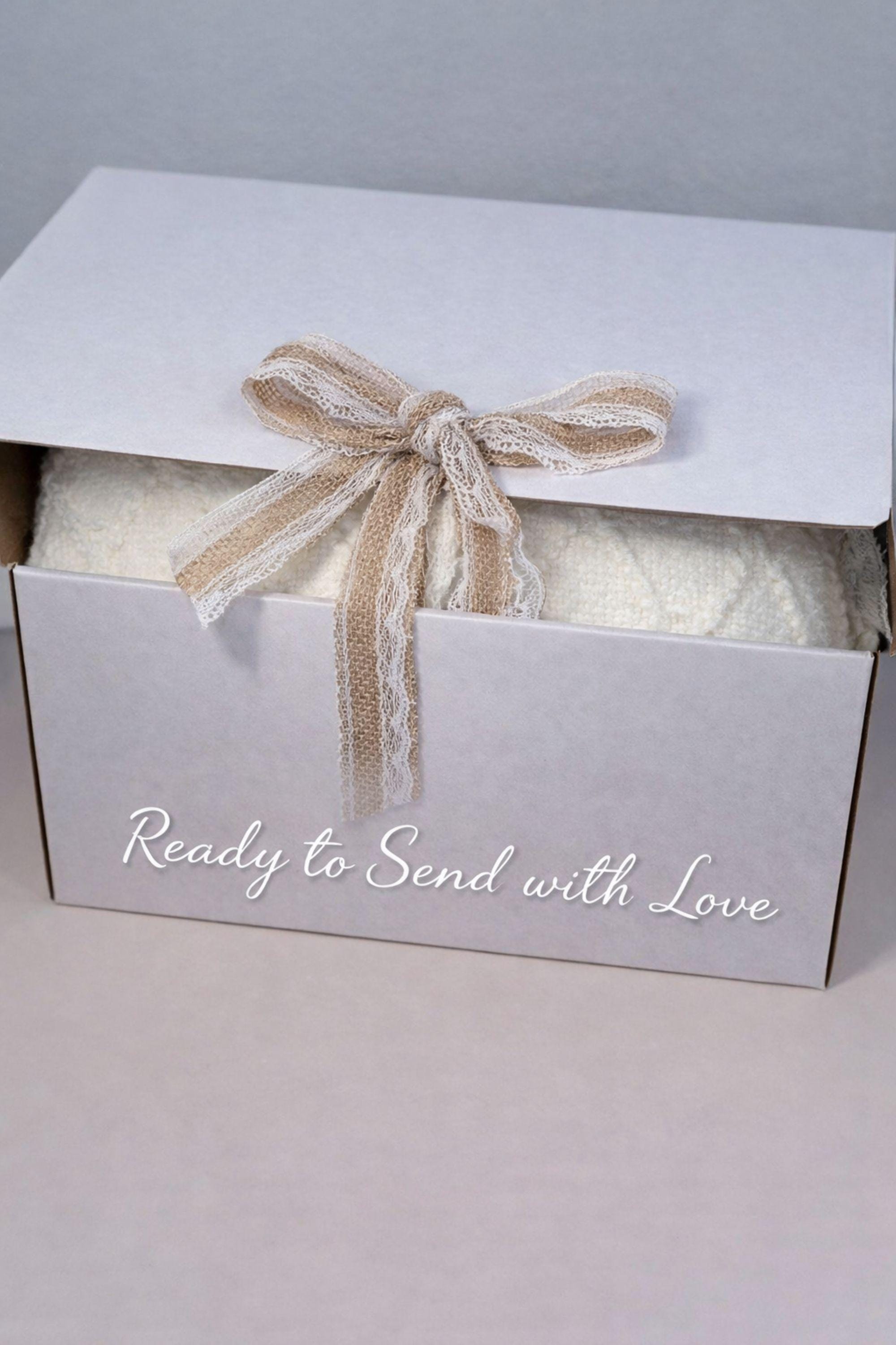 Breakup comfort gift box with cozy blanket, ceramic mug with gold spoon, plush teddy bear, handmade soap and face cloth arranged in gift box. Emotional support care package designed as a healing self care gift and thinking of you gift for friend going through breakup or difficult time.