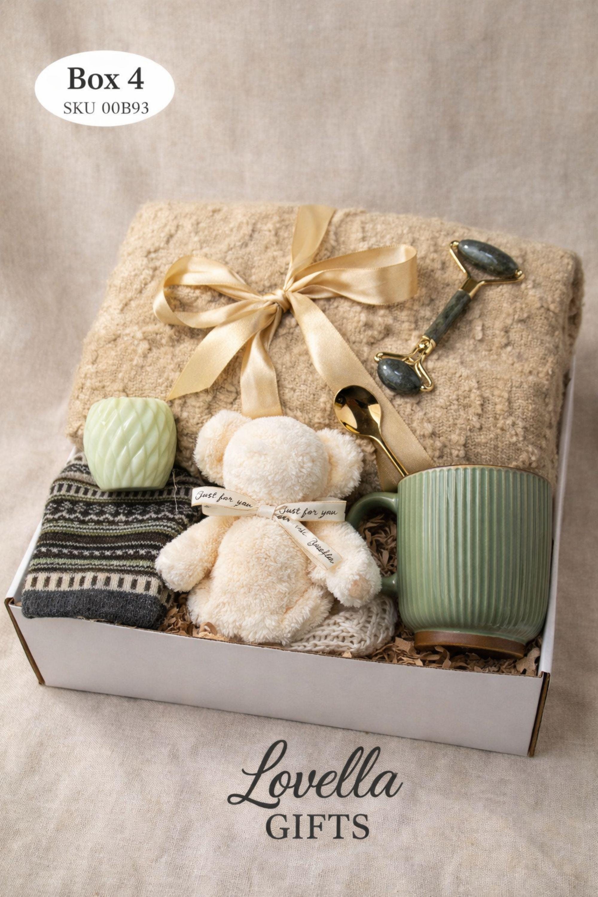 Breakup comfort gift box with cozy blanket, ceramic mug with gold spoon, plush teddy bear, handmade soap and face cloth arranged in gift box. Emotional support care package designed as a healing self care gift and thinking of you gift for friend going through breakup or difficult time.