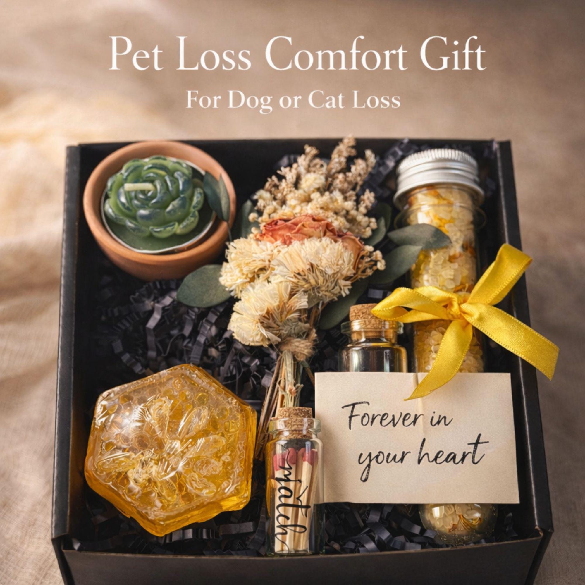 Pet loss sympathy gift box with memorial candle, honey soap, dried flowers, bath salts and matches arranged in elegant black gift box. Comfort care package designed as dog or cat memorial gift for grieving pet owner. Thoughtful pet bereavement gift with remembrance candle and self care elements to offer support after the loss of a beloved pet.