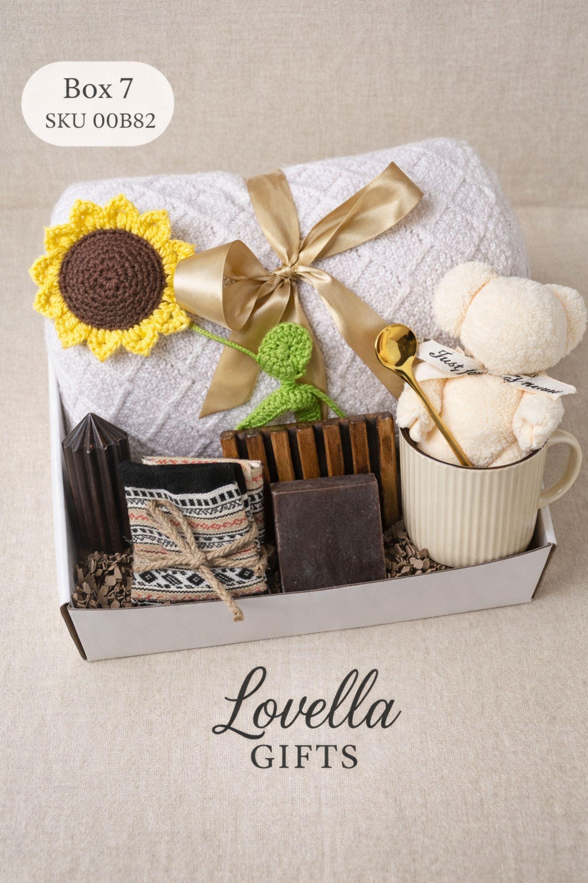 Breakup comfort gift box with cozy blanket, ceramic mug with gold spoon, plush teddy bear, handmade soap and face cloth arranged in gift box. Emotional support care package designed as a healing self care gift and thinking of you gift for friend going through breakup or difficult time.