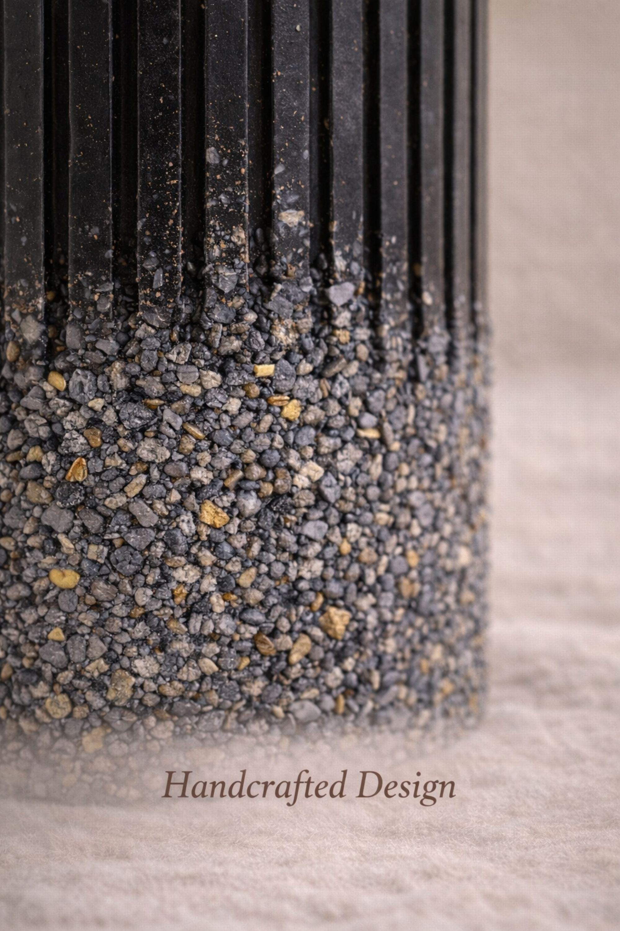 Close up of textured black memorial candle with ribbed upper design and stone-like base with gold accents, elegant handmade pet memorial candle designed as dog loss remembrance gift.
