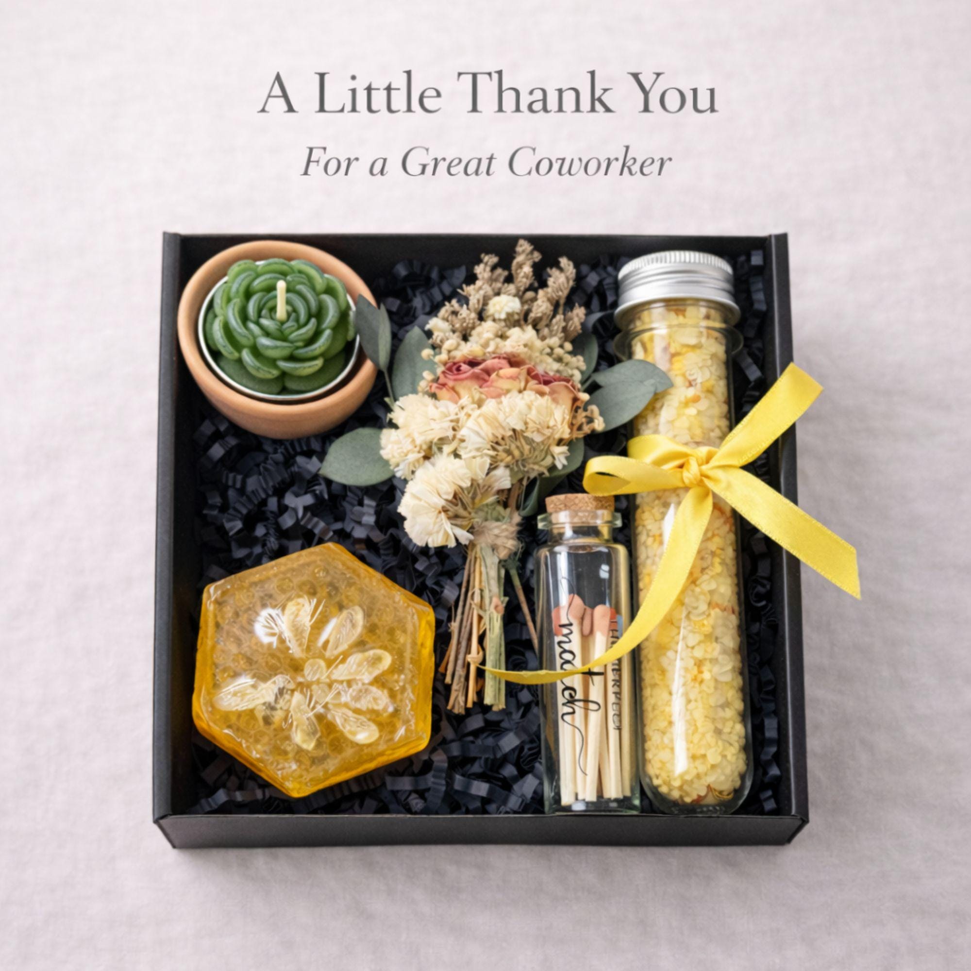 Small coworker appreciation gift box featuring succulent candle, handmade soap, bath salts, matches and dried flowers in black box with yellow ribbon, thoughtful thank you gift for coworker, friend or office team, compact 6x6 inch care package perfect for desk gift, employee appreciation, workplace gifting and meaningful everyday thank you presents