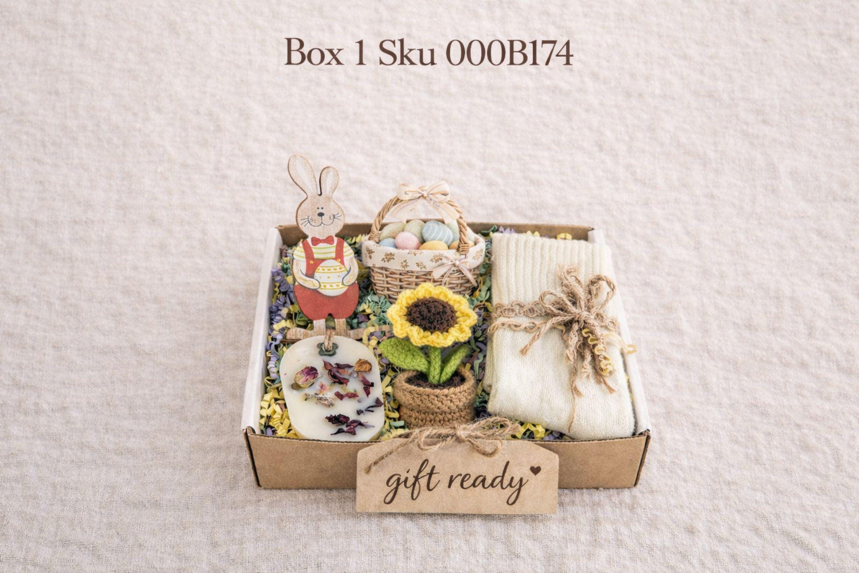 small easter gift box with wooden bunny decoration, crochet sunflower in pot, handmade botanical wax sachet, mini easter basket with eggs, soft neutral cloth wrapped with twine, colorful paper filler, spring themed gift box for women, ready to gift easter care package, cozy handmade spring gift set, pastel aesthetic small gift box