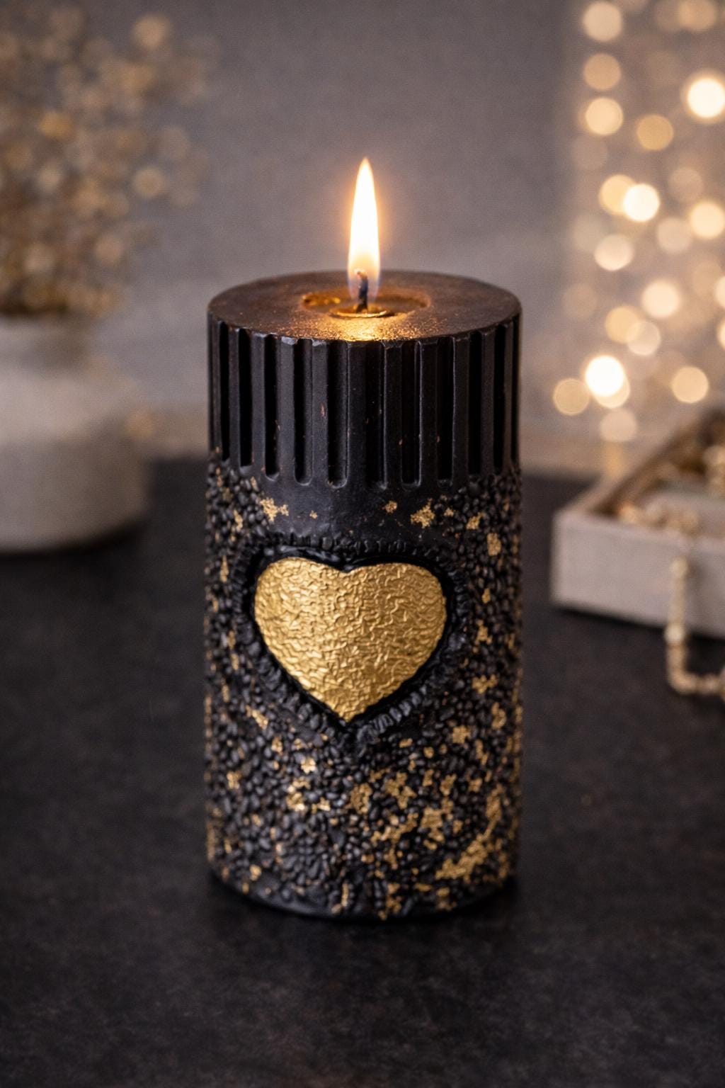 Black gold sculptural candle burning with warm flame, luxury decorative candle, modern home decor candle, aesthetic black and gold candle, romantic ambiance candle, unique gift for her
