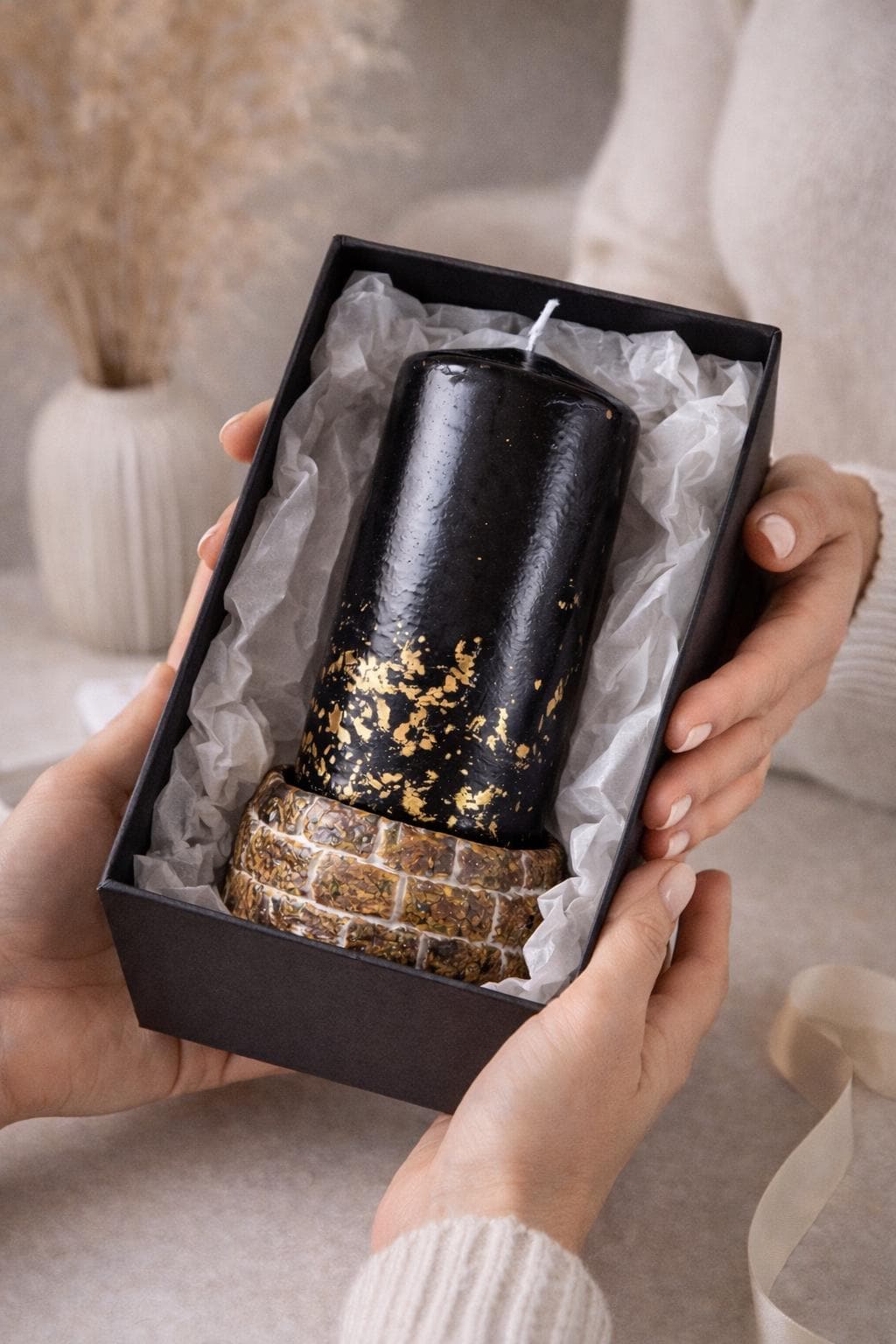 black decorative candle gift box being given as present luxury home decor