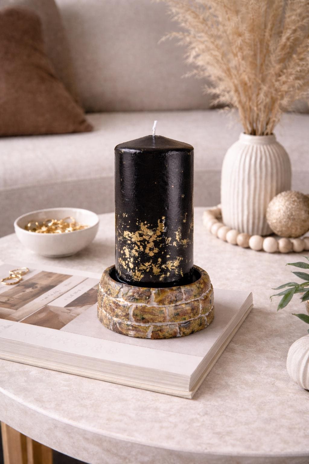 black decorative candle with gold accents minimalist luxury home decor