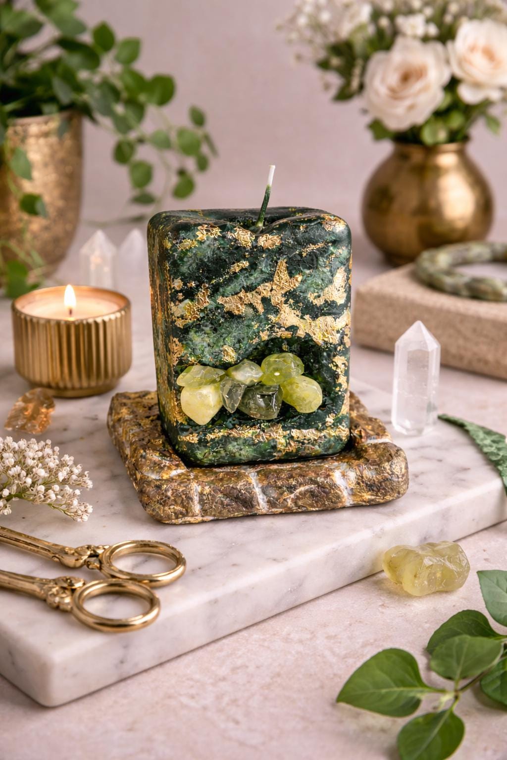 green prehnite crystal candle with gold leaf styled with crystals and flowers luxury decor