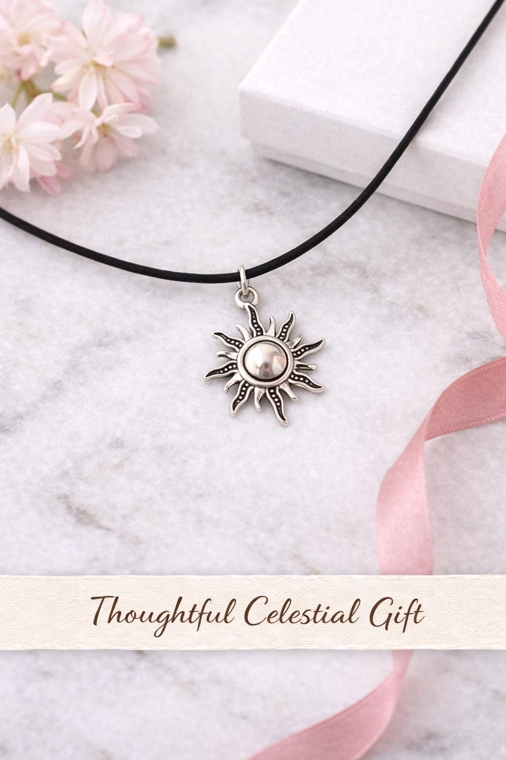 silver sun pendant necklace on marble background with gift box and flowers celestial jewelry minimalist sun charm choker gift for her aesthetic photo