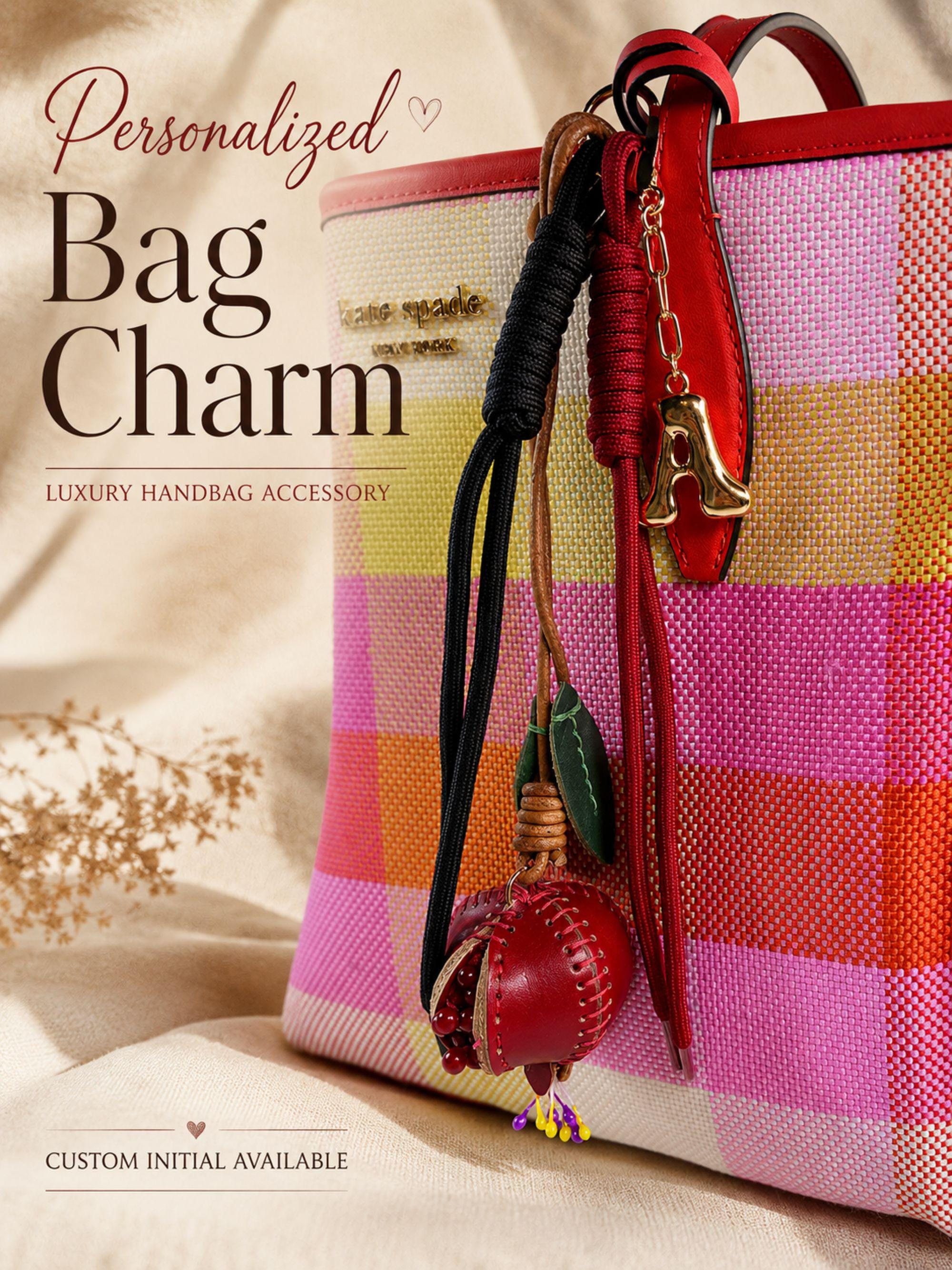 Personalized initial bag charm attached to colorful luxury tote bag with red leather trim, featuring handcrafted tassel cords, gold letter charm, artisan leather fruit accessory and boutique handbag styling. Luxury purse charm accessory for women, colorful handbag keychain, trendy tote bag decor, designer inspired purse accessory, custom initial charm gift for her, summer bag accessory, cute handbag charm, stylish purse keychain.