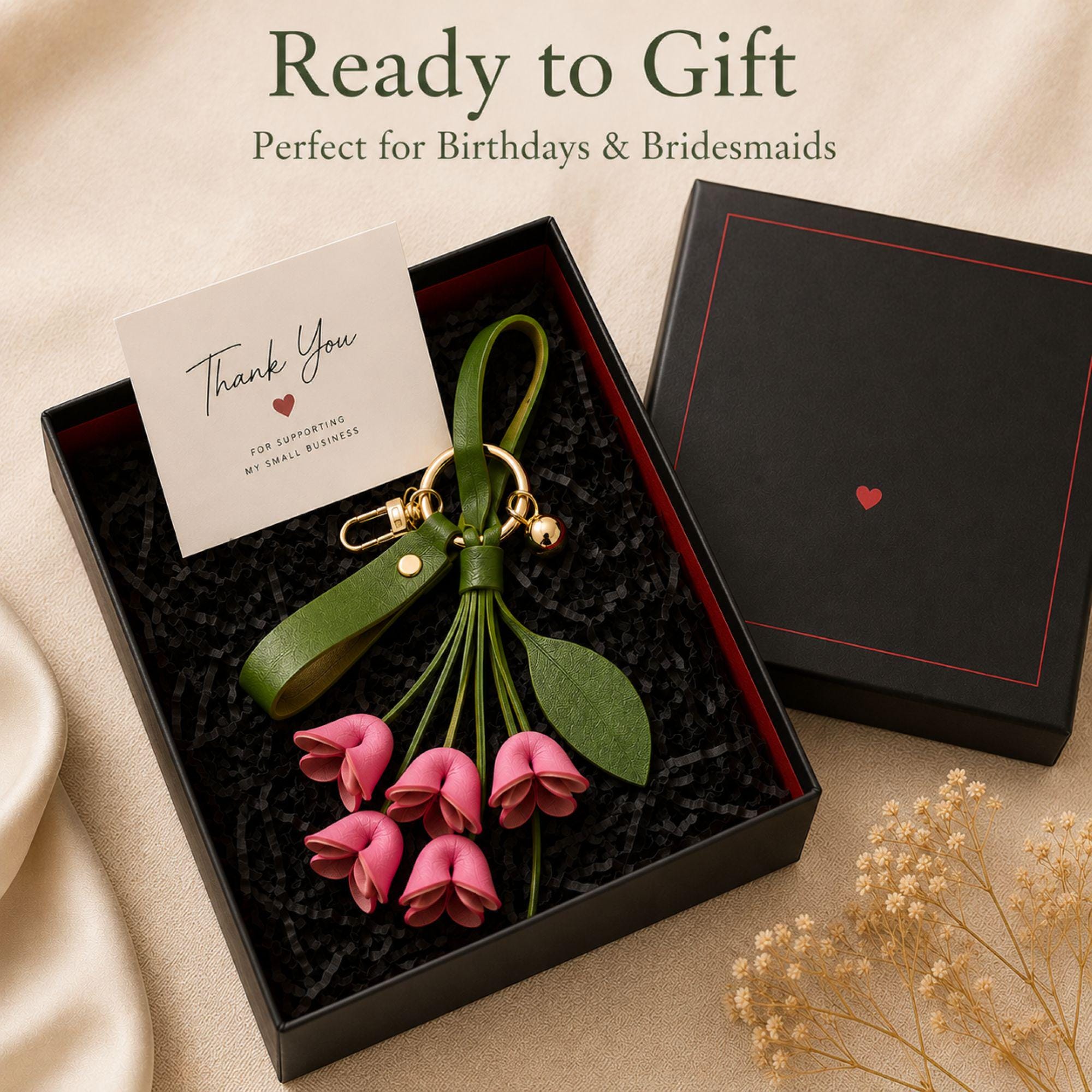 Rose Madder floral bag charm attached to luxury handbag featuring folded leather flowers, olive green leather strap, gold hardware, feminine purse accessory, trendy floral keychain, cute handbag charm, quiet luxury aesthetic, pink leather flower bag accessory, stylish purse charm for women, gift for her, luxury bag accessory, boutique fashion keychain, elegant floral purse accessory, Pinterest inspired handbag charm, soft feminine fashion accessory