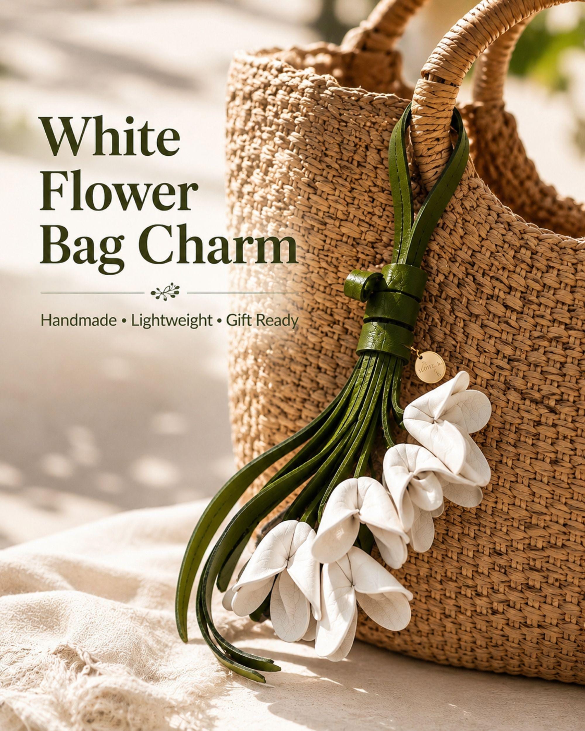 Handmade white flower bag charm featuring delicate white leather flowers attached to flowing green leather tassels with gold hardware. Floral purse charm designed for tote bags, handbags, backpacks, woven straw bags, beach bags, canvas totes, and everyday purses. Lightweight handbag accessory inspired by cottagecore, boho, feminine, and floral fashion trends. Unique gift for women, mom, sister, daughter, best friend, bridesmaid, and flower lovers.