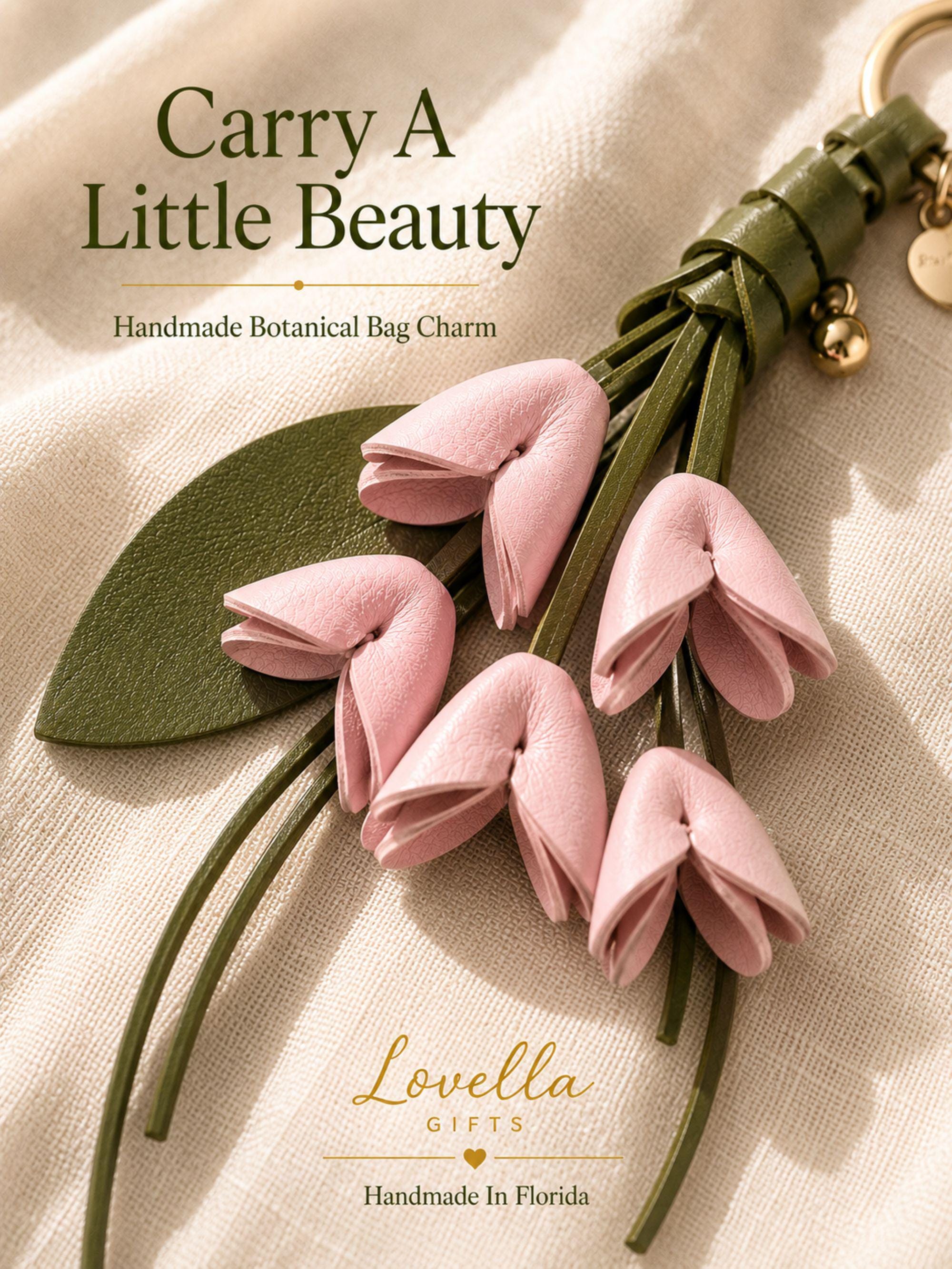 Luxury Botanical Bag Charm close-up with blush leather flowers, olive tassel and gold hardware for handbag styling.