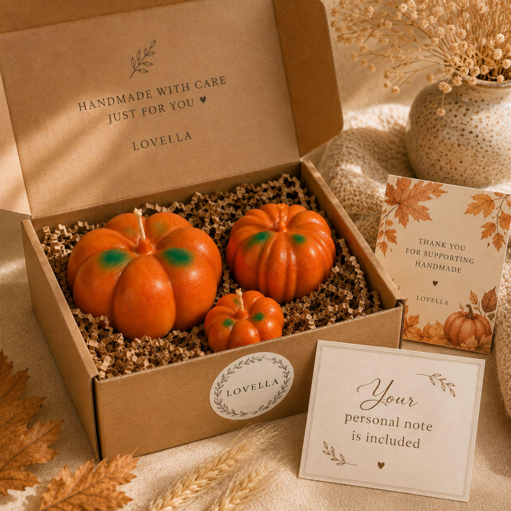 Gift ready pumpkin candle set of three presented in a kraft gift box with protective crinkle paper and Lovella packaging. Handmade large, medium and small orange pumpkin shaped candles feature a cozy Pumpkin Pie scent and make a thoughtful fall hostess gift, Thanksgiving gift, housewarming gift or autumn birthday gift. Seasonal candle trio arrives beautifully presented for easy fall gifting.