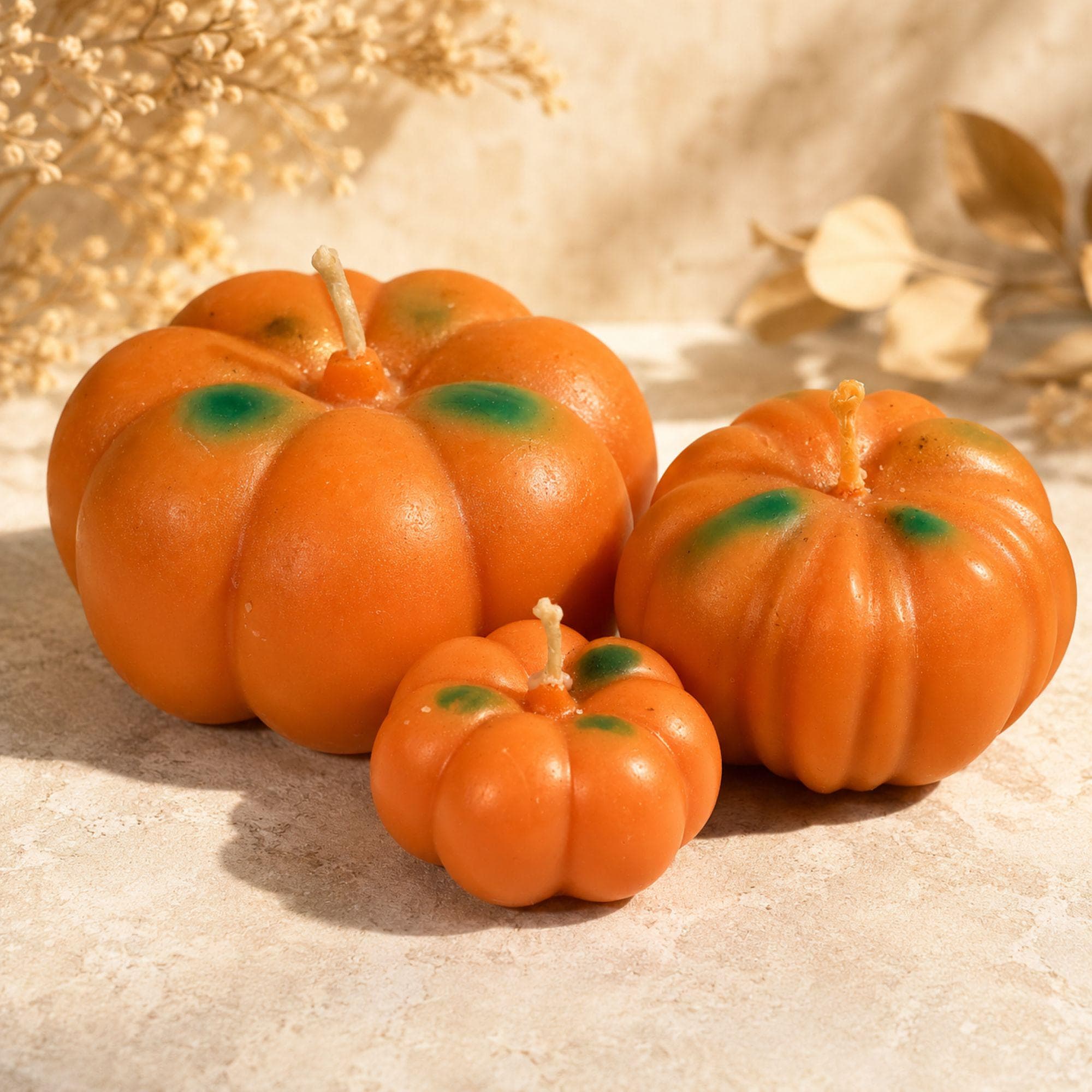 Pumpkin candle trio with three handmade orange pumpkin candles in large, medium and small sizes. Coordinating Pumpkin Pie scented candles create a dimensional fall decor display for an autumn centerpiece, Thanksgiving table, fireplace mantel, coffee table or entryway. Handmade pumpkin candle set combines seasonal pumpkin decor with cozy fall candle styling for Thanksgiving and autumn entertaining.